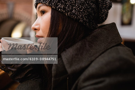 Close-up of woman having a coffee in the supermarket