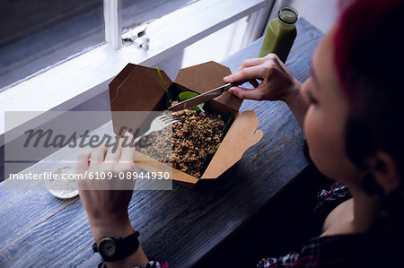 Beautiful woman having a salad in café