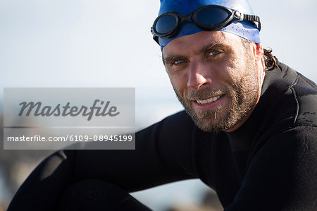 Portrait of confident sportsman on sunny day