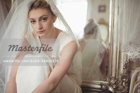 Portrait of young bride in a white dress at boutique