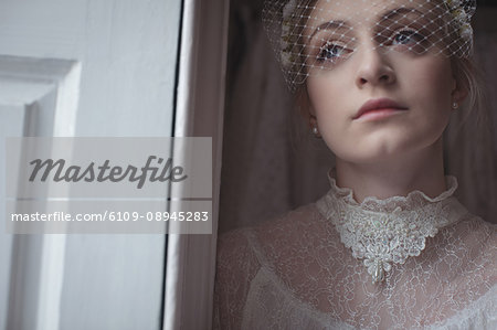 Close-up of young bridal wearing birdcage veil in a boutique