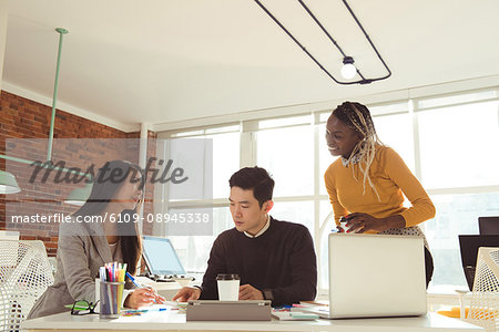 Group of executives working together at desk in office