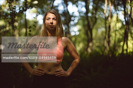 Beautiful woman exercising in the forest