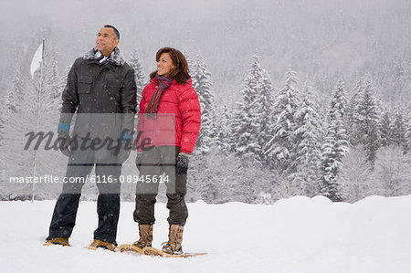 Portrait of a mature couple wearing snowshoes