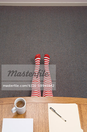 Office worker hiding under desk