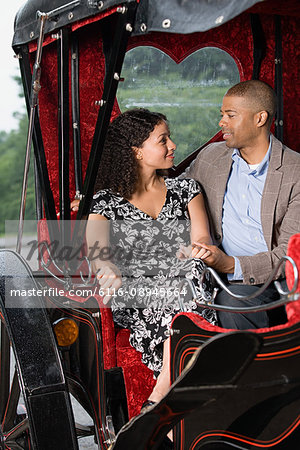 Couple sat in horse drawn carriage