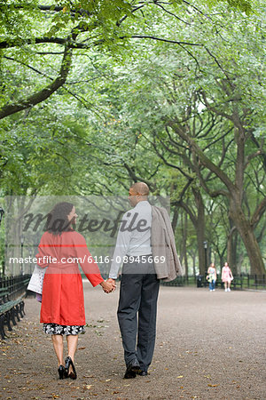 Couple holding hands in the park