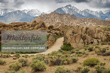 Dirt road through the Alabama Hills with the Sierra Nevada Mountians in the background in Eastern California, USA
