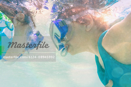 Boy and girl snorkeling underwater