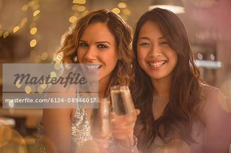 Portrait smiling women friends toasting champagne flutes