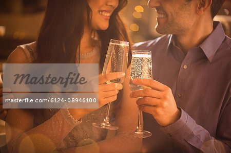 Affectionate couple toasting champagne flutes