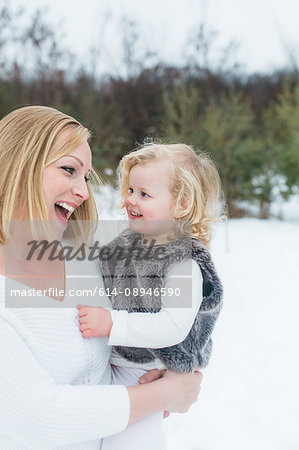 Mother and daughter in snow-covered park, Oshawa, Canada