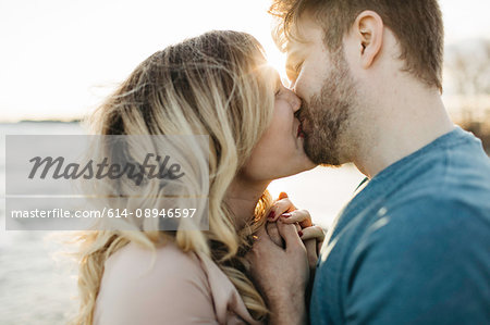 Couple kissing, outdoors, close-up