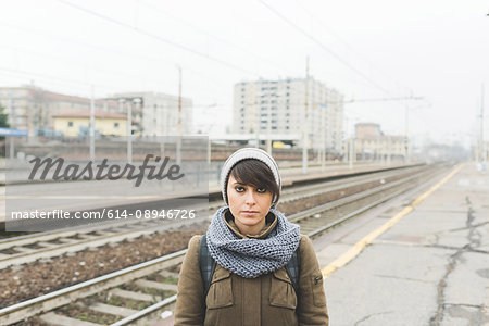 Portrait of woman in knit hat on railway platform
