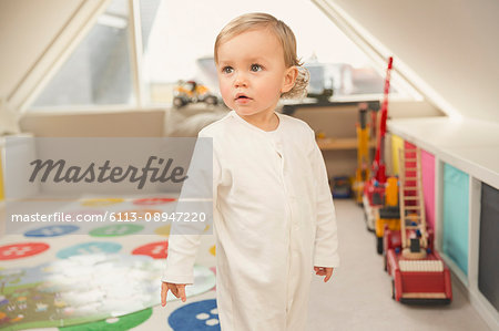 Cute toddler boy looking away in playroom