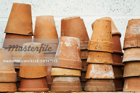 Close up of stacks of terracotta plant pots.