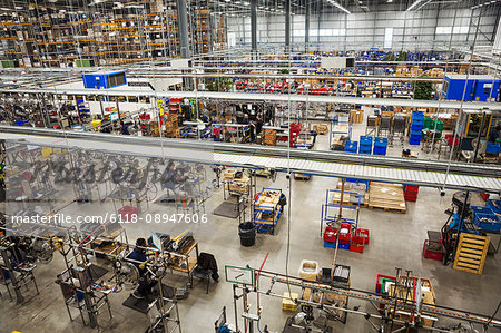 High angle interior view over the work floor, rows of machines in a bicycle factory.