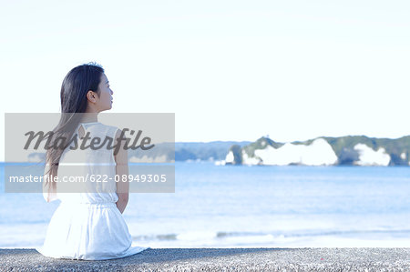 Young Japanese woman in a white dress by the sea, Chiba, Japan