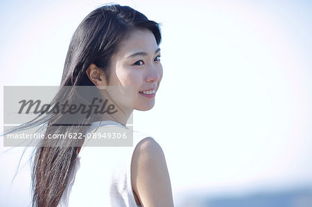 Young Japanese woman in a white dress by the sea, Chiba, Japan Young Japanese woman in a white dress by the sea, Chiba, Japan