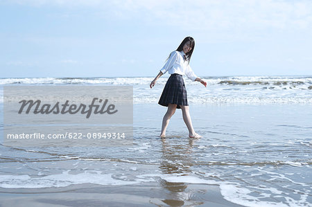 Young Japanese woman in a high school uniform by the sea, Chiba, Japan