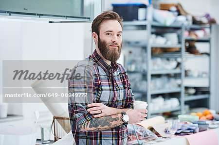 Portrait of young male designer in design studio