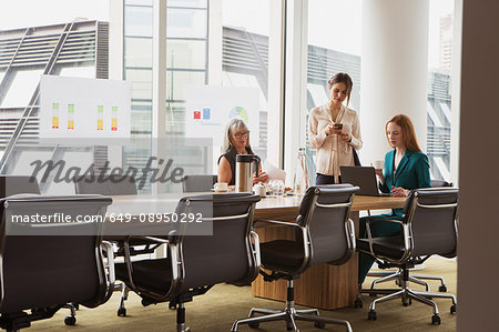Businesswomen preparing presentation in meeting room