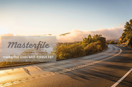 Highway and valley mist at sunrise, Yosemite National Park, California, USA Highway and valley mist at sunrise, Yosemite National Park, California, USA