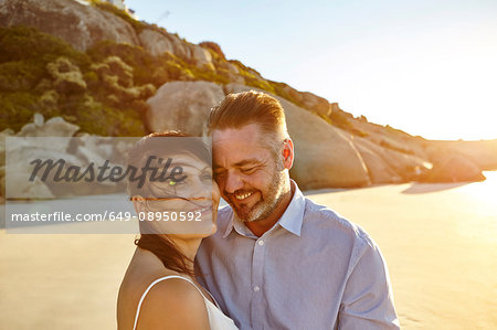 Portrait of mature couple, on beach, smiling, Cape Town, South Africa