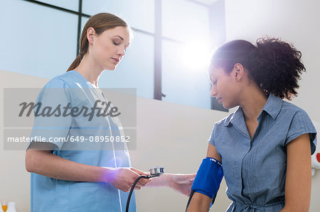 Doctor taking patient's blood pressure