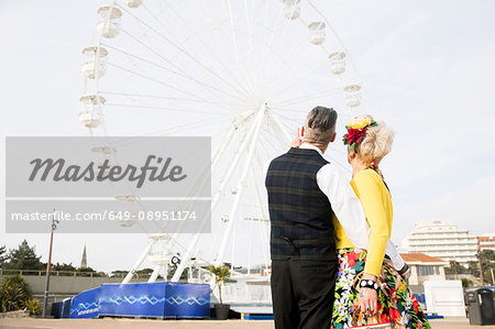 1950's vintage style couple pointing at ferris wheel