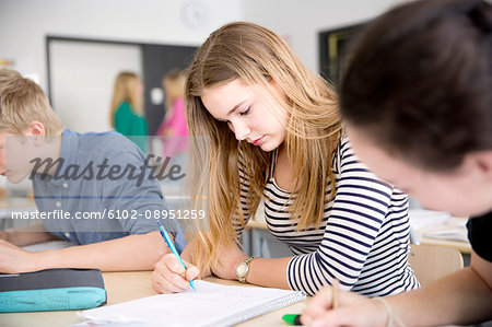 Teenage girl studying in classroom