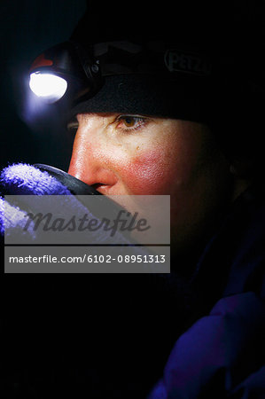 Woman drinking hot drink in tent
