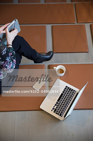 Woman with laptop and mobile phone