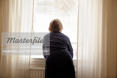 Woman looking trough window