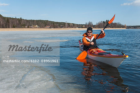 Man kayaking on river