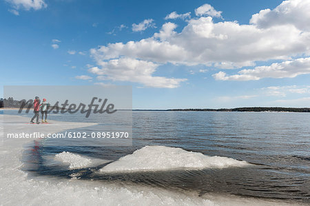 Man and woman standing on ice floe