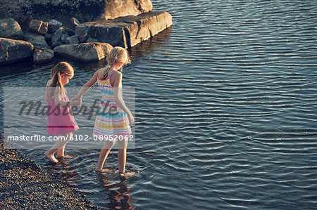 Girls wading in lake