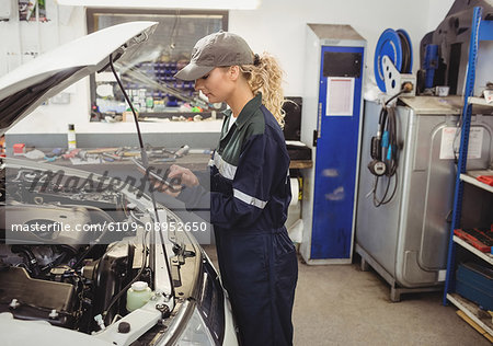 Female mechanic using digital tablet