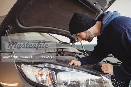 Mechanic servicing car