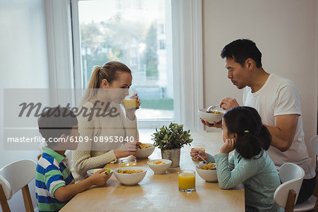 Family having meal on dining table at home