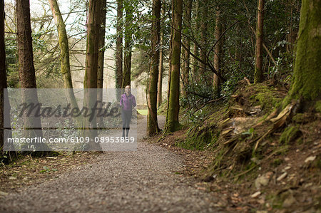 Beautiful woman jogging in forest