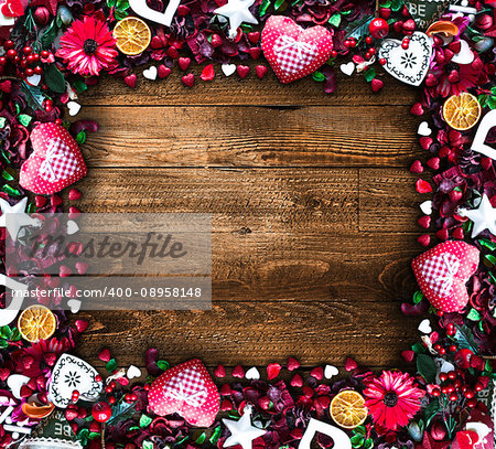 Valentine's Day Background with love themed elements like cotton and paper hearts, flowers, berries, oranges and other decorations. Wooden old parquet on the back.