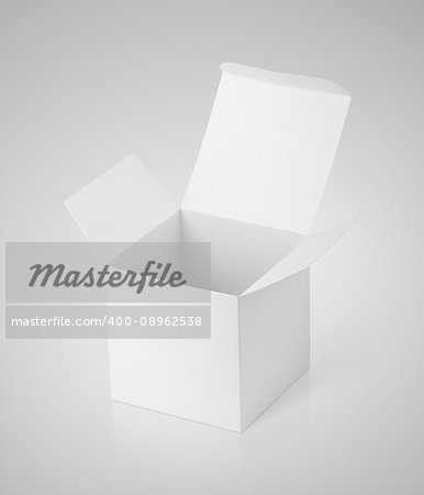Open white cardboard box on gray background with clipping path. White paper box with reflection