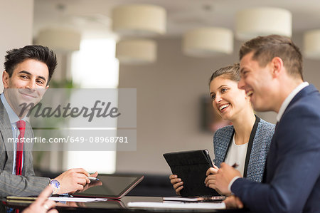 Businesswoman meeting male colleagues in boardroom