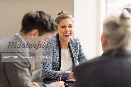 Businessman meeting female colleagues in boardroom Businessman meeting female colleagues in boardroom