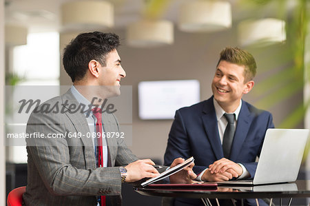Two businessmen meeting in boardroom