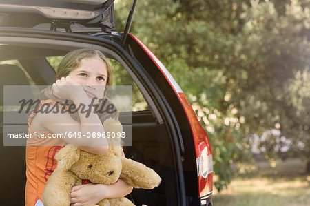 Sullen girl with teddy bear