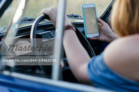 Woman using smartphone while driving, Firenze, Toscana, Italy, Europe