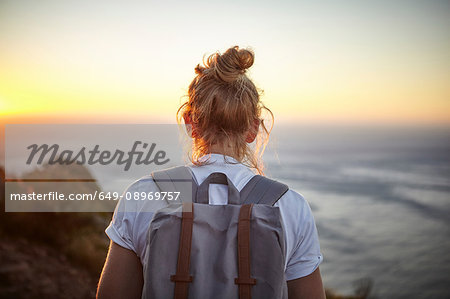 Young woman hiking, rear view, Lions head Mountain, Western Cape, Cape Town, South Africa