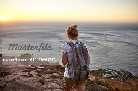 Young woman hiking, rear view, Lions head Mountain, Western Cape, Cape Town, South Africa